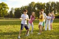 Happy joyful kids playing in tug-of-war with a rope in the summer park in nature in children camp. Royalty Free Stock Photo