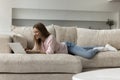 Happy joyful laptop user woman resting on sofa Royalty Free Stock Photo