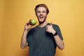 Happy Joyful Man Holding Green Apple and Thumbs Up Royalty Free Stock Photo