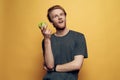 Happy joyful man holding green apple and thumbs up Royalty Free Stock Photo