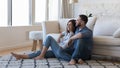 Happy joyful married couple resting on warm carpeted floor Royalty Free Stock Photo