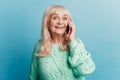 Happy joyful mature woman talking on smartphone isolated on blue background Royalty Free Stock Photo