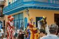 happy joyful people walking and participating in Cuban carnival on Havana city street