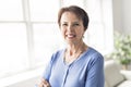 Happy joyful senior lady in front of a window Royalty Free Stock Photo