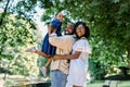 Happy joyful young African family, father, mother and little daughter, having fun outdoors, playing together in summer Royalty Free Stock Photo