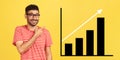 happy joyful young bearded man standing, pointing aside and showing business growth graph. Royalty Free Stock Photo