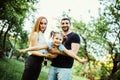 Happy joyful young family father, mother and little daughter having fun outdoors, playing together in summer park. Daughter raided Royalty Free Stock Photo