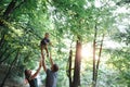 Happy joyful young family father, mother and little son having fun outdoors, playing together in summer park Royalty Free Stock Photo