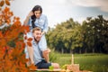 Happy joyful young family husband and his pregnant wife having fun together outdoors, at picnic in summer park Royalty Free Stock Photo