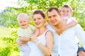 Happy joyful young family in summer park Royalty Free Stock Photo