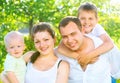 Happy joyful young family in summer park Royalty Free Stock Photo