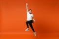 Happy joyful young man in casual white t-shirt posing isolated on bright orange wall background studio portrait. People Royalty Free Stock Photo