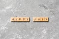 Happy july word written on wood block. Happy july text on table, concept Royalty Free Stock Photo