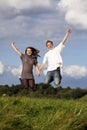 Happy jumping teenage couple