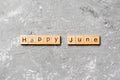 Happy June word written on wood block. Happy June text on table, concept