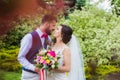 Happy just married couple kissing in green garden Royalty Free Stock Photo
