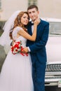 Happy just married couple posing in the background of vintage car Royalty Free Stock Photo