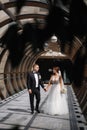 Happy just married couple walking beautiful round window in wedding day Royalty Free Stock Photo