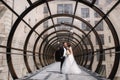 Happy just married couple walking beautiful round window in wedding day Royalty Free Stock Photo