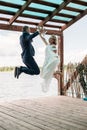 Happy just married young wedding couple celebrating and have fun jumping Royalty Free Stock Photo