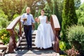 Happy just married young wedding couple having fun in the park. Bride and groom together, love and marriage theme. Royalty Free Stock Photo