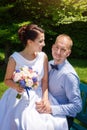 Happy just married young wedding couple having fun in the park. Bride and groom together, love and marriage theme. Royalty Free Stock Photo