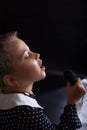 Happy karaoke time. Kids love music. Little girl sing on black background Royalty Free Stock Photo