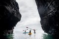 Happy kayakers sea rock walk kayaks Royalty Free Stock Photo