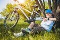 Happy kid with a bicycle resting under a tree Royalty Free Stock Photo