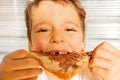 Happy kid boy eating toast with chocolate spread Royalty Free Stock Photo