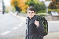 Happy kid boy with glasses and backpack or satchel. Schoolkid in stylish fashon coan on the way to middle or high school Royalty Free Stock Photo