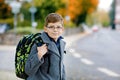 Happy kid boy with glasses and backpack or satchel. Schoolkid in stylish fashon coan on the way to middle or high school Royalty Free Stock Photo