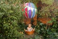 Happy kid boy having fun flying up on airship. Preschool boy traveling