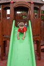 Happy kid boy having fun and sliding on outdoor playground Royalty Free Stock Photo