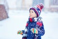 Happy kid boy having fun with snow in winter Royalty Free Stock Photo