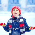 Happy kid boy having fun with snow in winter Royalty Free Stock Photo