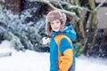 Happy kid boy having fun with snow in winter Royalty Free Stock Photo