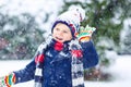 Happy kid boy having fun with snow in winter Royalty Free Stock Photo