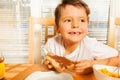 Happy kid boy holding toast with chocolate spread Royalty Free Stock Photo