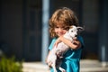 Happy kid boy hugging a dog. Cute child and puppy playing outside. Royalty Free Stock Photo