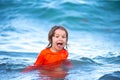 Happy kid boy playing and having fun on the beach on blue sea in summer. Blue ocean with wawes. Child boy swimming in Royalty Free Stock Photo