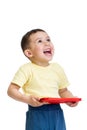 Happy kid boy playing with pc tablet looking up Royalty Free Stock Photo