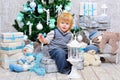 Happy kid by the Christmas tree Royalty Free Stock Photo