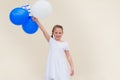 Happy little girl with blue and white balloons ans Israel flag. Royalty Free Stock Photo