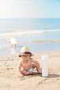 Happy kid with dad hat playing with sand on beach Royalty Free Stock Photo