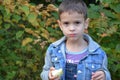 Happy kid eating fruits. happy cute child boy eating an apple. in an autumn park Royalty Free Stock Photo