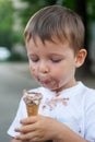 Happy kid eating ice cream. Boy with a dirty face eating ice cream Royalty Free Stock Photo