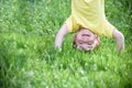 Happy kid enjoying sunny late summer and autumn day in nature on green grass. Royalty Free Stock Photo