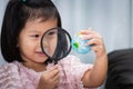 Happy kid exploring globe map with magnifying glass. Child aged 4-5 years old Royalty Free Stock Photo