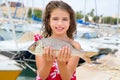 Happy kid fisherwoman with dentex fish catch